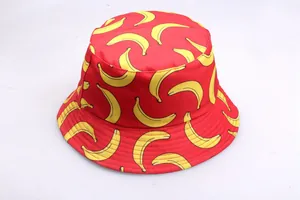 Detail view of red reversible bucket hat featuring all-over yellow banana print patterns