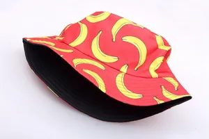 Detail of red bucket hat featuring vibrant yellow banana prints and a black inner lining