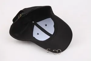 Detail of adjustable metal buckle and inner stitching on a black cotton baseball cap