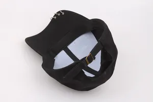 Detail of black cotton baseball cap with silver metal rings and adjustable copper buckle