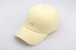 Detail of light yellow baseball cap featuring orange OFF embroidery and reinforced stitching