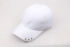 Detail of white cotton baseball cap showing three silver metal rings on the brim