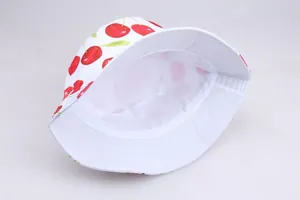 Detail of red cherry printed cotton bucket hat featuring high-quality white inner lining