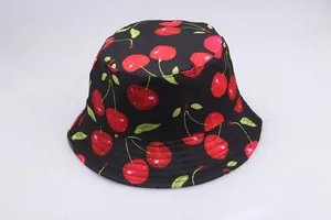 Top-down view of a black bucket hat featuring cute red cherry prints and neat stitching