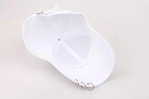 Detailed view of white baseball cap interior with three silver ring accents on the brim