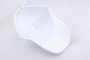 Internal structure of white cotton baseball cap showing plastic support and adjustable strap