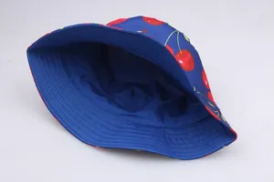 Flat lay of navy blue bucket hat featuring vibrant red cherry prints and cotton texture