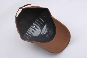 Detail view of brown baseball cap interior with sweatband and adjustable metal buckle