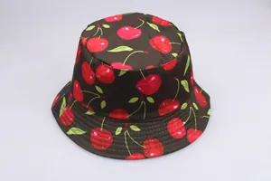 Close-up of a dark bucket hat featuring vibrant red cherry patterns and reinforced stitching