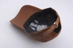 Detail view of cotton baseball cap with adjustable silver metal buckle and interior structure