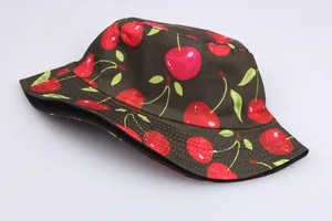 Detailed texture of dark brown bucket hat with red cherry print and reinforced stitching