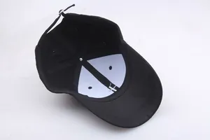 Inside view of black cotton baseball cap with six-panel structure and adjustable buckle
