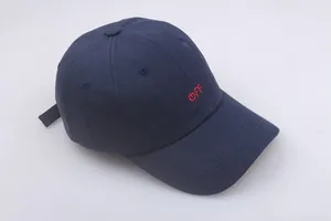 Detail of navy blue cotton baseball cap with red embroidered power icon and letters