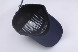 Detailed view of navy blue cotton baseball cap with adjustable metal buckle strap