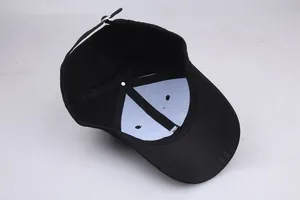 Inside view of black cotton baseball cap with cross embroidery and adjustable buckle
