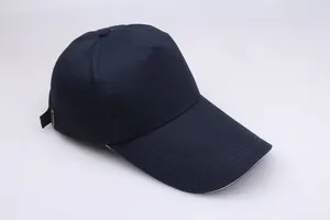 Detail of navy blue cotton baseball cap with adjustable metal buckle and long visor