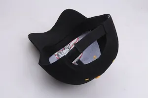 Detail view of adjustable back strap and breathable yellow vents on black cotton baseball cap