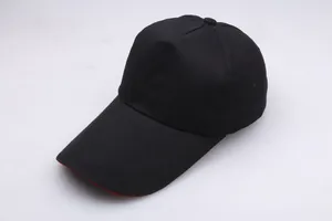 Detail view of the black baseball cap with contrast red underside and extended sun brim