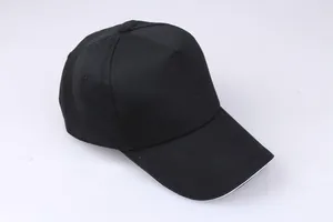 Close-up of black cotton baseball cap showing twill texture and white sandwich brim detail