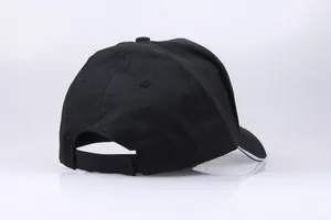 Detail view of black cotton baseball cap back with adjustable velcro closure strap