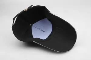 Detail of the adjustable metal buckle and stitching on the black sun hat crown