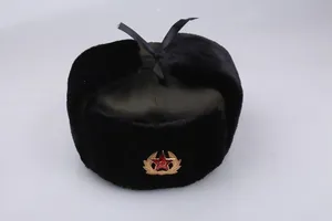Detailed view of the Soviet style winter hat with faux fur and metallic red star badge
