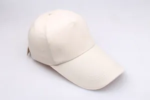 Close-up of beige baseball cap with long brim and detailed cotton twill stitching