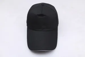 Close-up of black cotton twill baseball cap with white sandwich brim detail and crown button