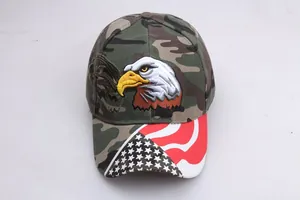Macro shot of eagle embroidery and American flag patterns on a camouflage baseball cap