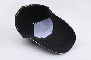 Detail of internal black baseball cap structure with white lining and metal adjustment buckle
