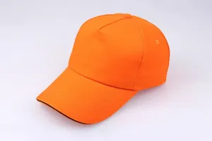 Close-up of bright orange cotton baseball cap showing visor stitching and eyelet details