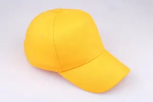 Top view of a bright yellow cotton baseball cap showing reinforced stitching and crown button
