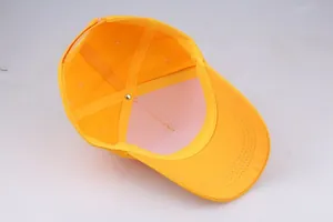 Internal details of bright yellow cotton baseball cap with six-panel structure and reinforced seams