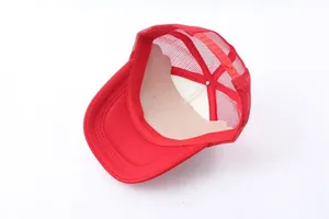 Detail of red trucker hat featuring breathable mesh back and adjustable snapback closure