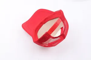 Detail view of red trucker hat featuring mesh back and plastic snapback closure
