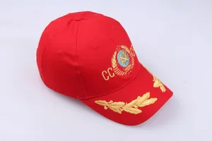 Detail of red CCCP baseball cap featuring gold sickle hammer embroidery and laurel leaves
