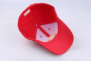 Detail view of red baseball cap interior featuring golden embroidery and white lining