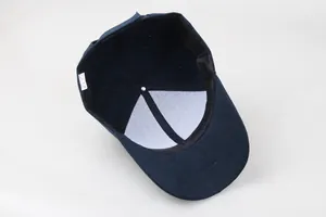 Detail shot of navy baseball cap interior showing 100% cotton label and stitching