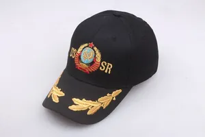 Detail of USSR emblem and gold embroidery on black cotton baseball cap surface