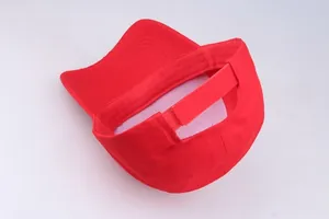 Detail view of red cotton baseball cap featuring adjustable hook and loop back strap