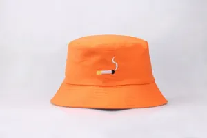 Macro detail of high-quality cigarette embroidery on bright orange cotton bucket hat