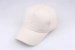 Close-up of beige cotton baseball cap with six-panel structure and curved brim detail