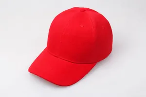 Close-up of a red cotton baseball cap showing twill fabric texture and stitched eyelets