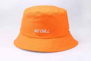 Close-up of bright orange bucket hat featuring white NO CHILL embroidery and cotton texture