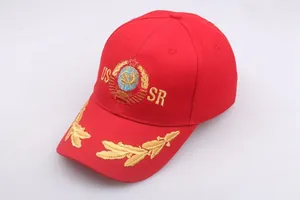 Close-up of golden USSR letters and Soviet emblem embroidery on a red cotton baseball cap