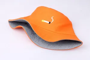 Detail of orange bucket hat with cigarette embroidery and contrasting gray lining