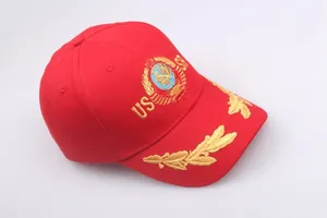 Close-up of golden USSR sickle and hammer embroidery on a red cotton baseball cap