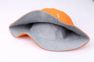 Detail of reversible fisherman hat showing orange outer fabric and gray inner lining