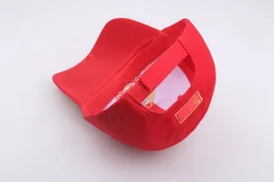 Close-up of the red baseball cap featuring a yellow Puma logo and velcro adjustment strap