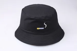 Detailed close-up of NO CHIL cigarette embroidery on a black cotton bucket hat